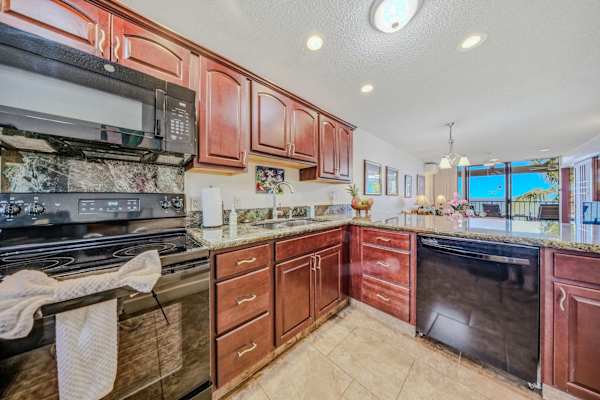 Spacious kitchen layout featuring wooden cabinetry, full appliances, and ample counter space. 🍳