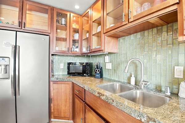 Kitchen Sink Area with Green Tile Backsplash