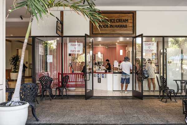 Treat yourself to a sweet, refreshing scoop at the local ice cream parlor, beautifully designed with a vibrant candy-striped interior and inviting sidewalk seating.