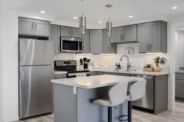Enjoy quick morning bites or evening drinks at the stylish center island in this fully updated, stainless-steel kitchen.