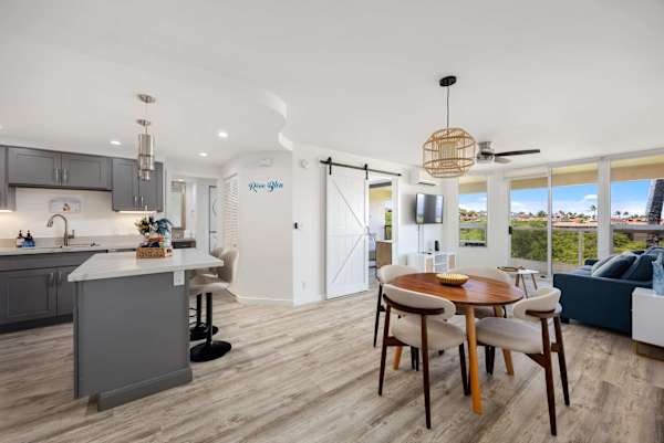 Experience seamless island living in your spacious, open-concept condo featuring a modern kitchen, stylish dining nook, and bright, breezy views.