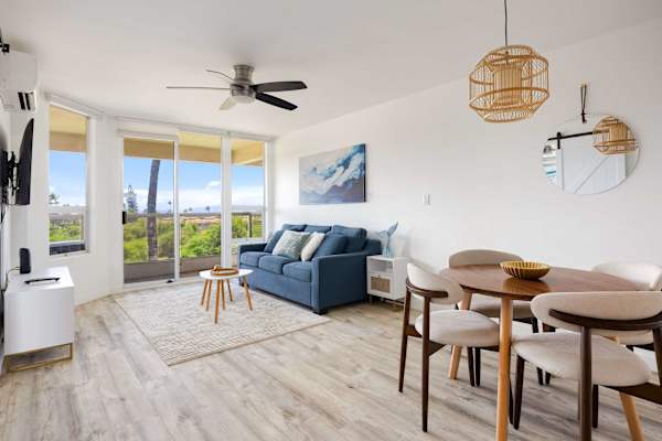 Bask in abundant natural light throughout this airy living space, complete with a cozy seating area, a stylish dining setup, and sweeping outdoor views.