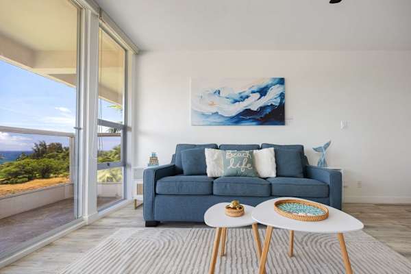 Lounge on the comfy ocean-blue sleeper sofa and soak in the bright, natural light and serene tropical views through floor-to-ceiling glass doors.