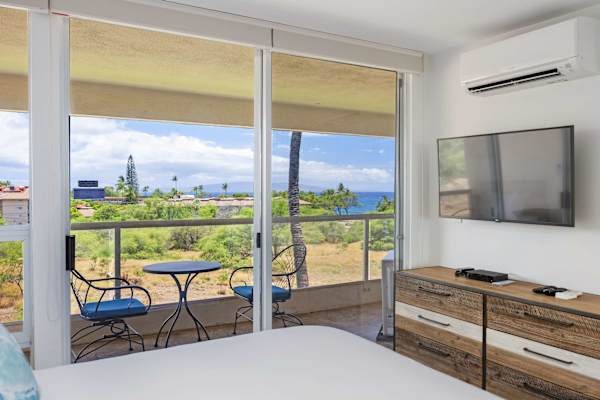 Wake up to panoramic ocean views from bed, equipped with wall-mounted A/C, 42" TV, and direct access to your private balcony.