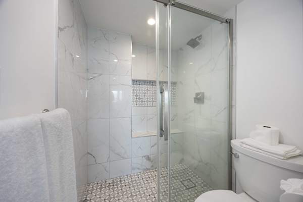Refresh and recharge in your bathroom, complete with an elegant, marble-tiled walk-in shower and premium finishes.