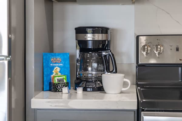Start your mornings right at the coffee station, complete with a drip coffee maker, fresh coffee, and an assortment of teas.