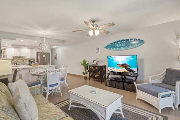 Experience an airy, open-concept layout connecting the comfortable living space, dining area, and fully updated kitchen for seamless relaxation and entertaining.