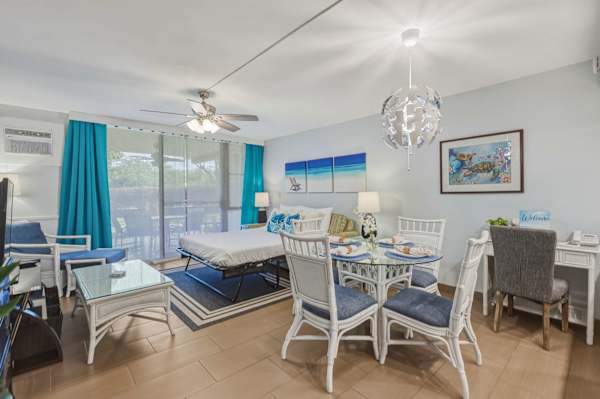 Enjoy bright, versatile living with a glass-top dining table, a dedicated workspace, and comfortable seating that seamlessly leads to the outdoor patio.
