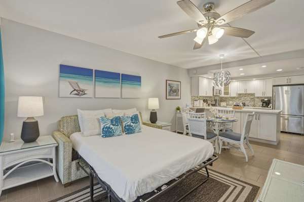 Your living area features a comfortable sleeper sofa connecting seamlessly to the dining area and fully equipped kitchen.