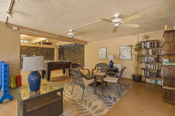 Unwind in the community game room, featuring cozy seating, bookshelves, a foosball table, and fun activities for all ages.