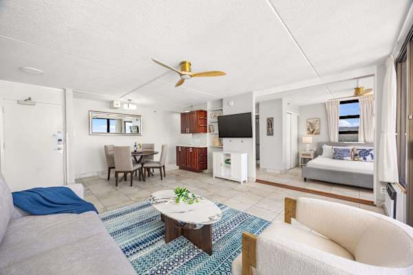 This bright, open layout offers comfortable living room seating, a formal dining area, and a stylish media setup, leading directly into your comfortable bedroom, separated by a sliding door.