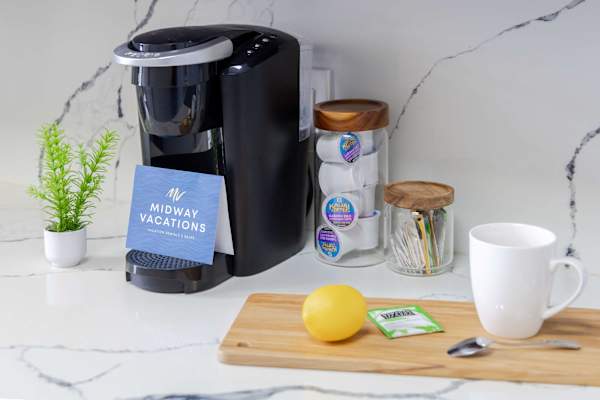 Start your mornings right with a fully equipped coffee station featuring a single-serve coffee maker, complementary pods, and all the essentials for your perfect morning brew.