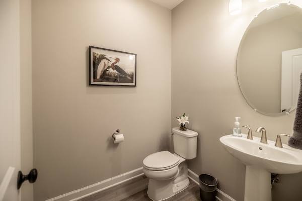 Powder Room - A convenient main-level half bath with a pedestal sink and clean finishes.