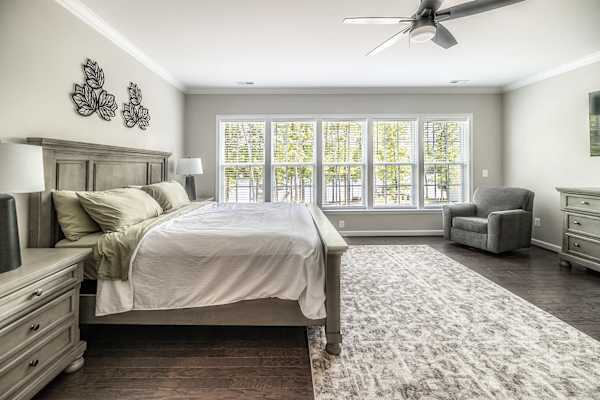 Primary Suite - Wake up to soft light and lake-facing windows in this spacious upper-level retreat.