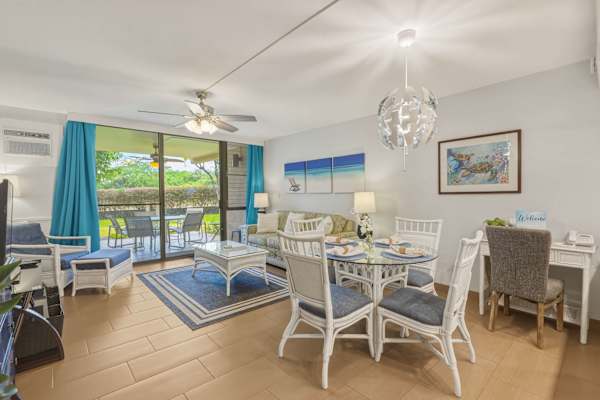 Your bright living space features a dining set, dedicated work desk, sleeper sofa, and sliding glass doors that lead directly to the outdoor patio.