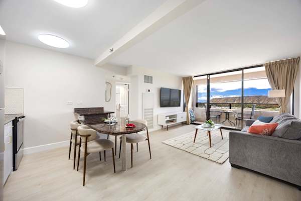 Enjoy an airy, open layout connecting dining and living spaces, framing sweeping views of Diamond Head right from your sofa.
