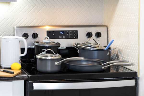 Prepare your favorite meals with ease using a full set of quality cookware, an electric kettle, and modern kitchen essentials.