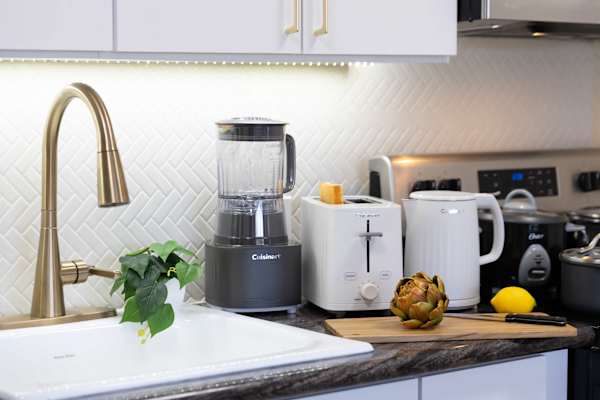 Whip up quick meals and refreshing smoothies using countertop appliances, including a blender, toaster, and electric kettle.