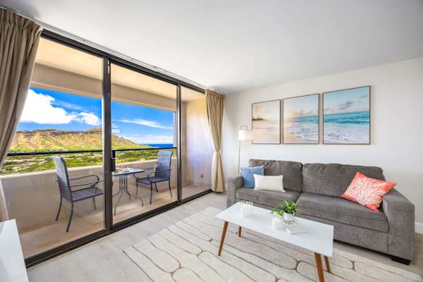 Bask in natural light and unforgettable Diamond Head views from your inviting living room designed for ultimate relaxation.