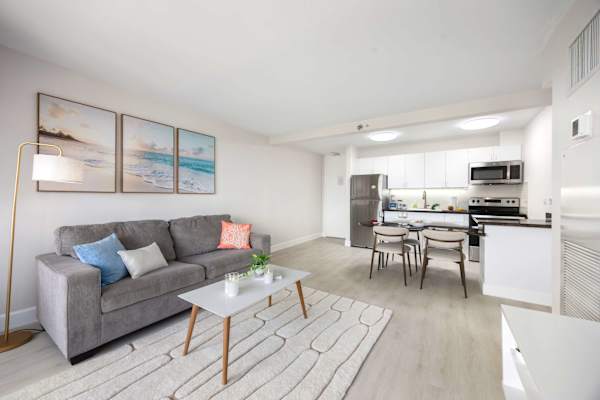 Relax in your spacious, light-filled living area that seamlessly opens to a modern kitchen and dining space.