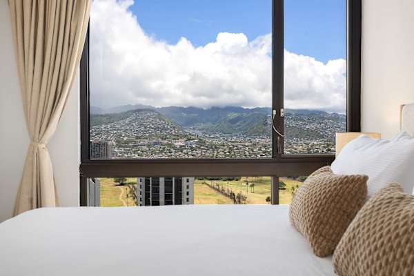 Wake up to expansive, elevated views of the mountains and cityscape right from the comfort of your bed.