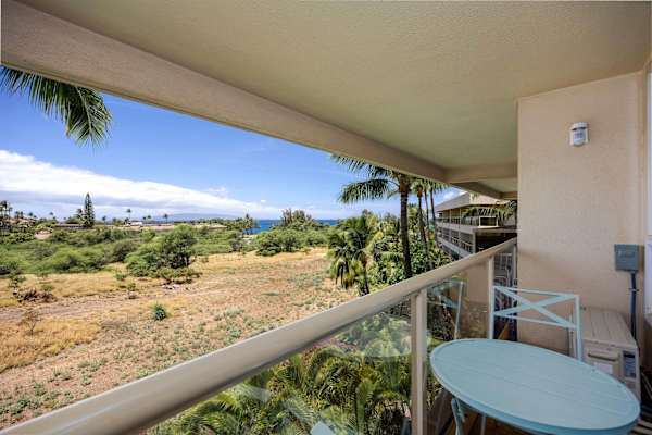 Step out onto your private covered balcony to enjoy outdoor seating and tranquil views reaching toward the coast.