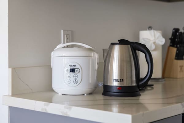Enjoy added convenience with handy countertop essentials, including a digital rice cooker and a fast-boiling stainless steel electric kettle.