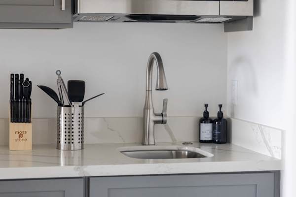 Experience seamless cooking in your kitchenette equipped with pristine quartz countertops, premium cutlery, and a sleek gooseneck faucet.