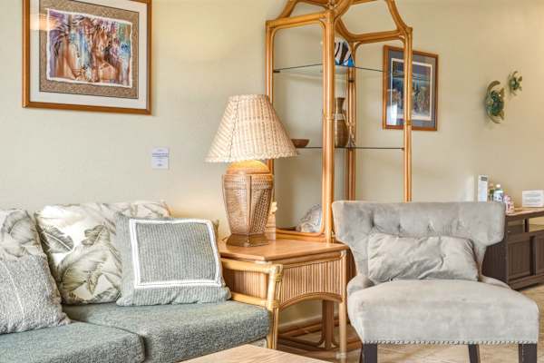 Sink into comfort with plush, tropical-inspired seating, elegant rattan shelving, and charming island accent decor.