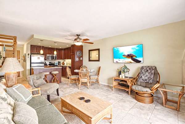 Experience coastal living at its finest in this bright, open-concept condo in Maui featuring a tropical-inspired living area and a fully equipped modern kitchen.