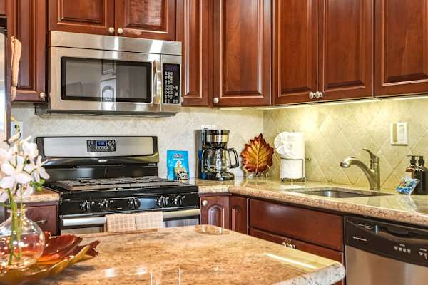 Cook with ease in your beautifully detailed kitchen with cabinets, granite countertops, and essential appliances.