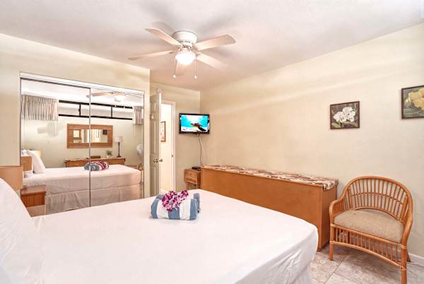 Rest peacefully in your serene bedroom, complete with a comfortable queen bed, wall-mounted 55" TV, mirrored closet, and charming tropical seating.