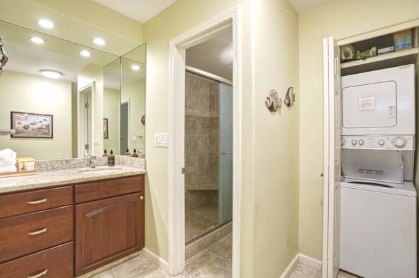 Refresh in style with a spacious full bathroom featuring a walk-in shower, vanity storage, and the convenience of an in-unit stacked washer and dryer.