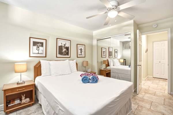Unwind in this bright and cozy bedroom featuring a plush queen bed, mirrored closet doors, and soothing neutral accents designed for ultimate relaxation.