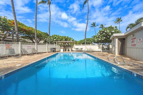Take a refreshing dip in the swimming pool, surrounded by towering palm trees and sunny tropical skies.