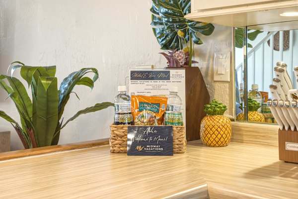 Feel right at home with a thoughtful welcome basket filled with local treats, bottled water, and helpful guest information waiting on the kitchen counter.