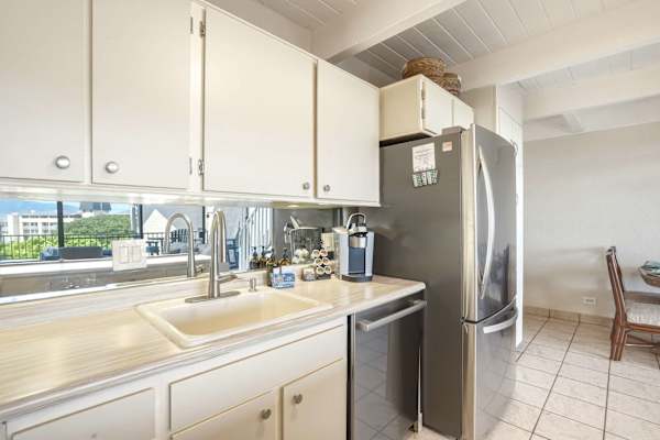 Clean and convenient, your kitchen area features a deep sink, stainless steel dishwasher, full-size refrigerator, and ample counter space for easy meal prep.