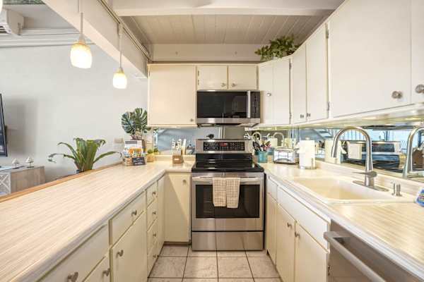 Your fully equipped kitchen offers modern stainless steel appliances, ample counter space, and a bright, functional layout perfect for home-cooked meals.