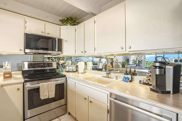 Your kitchen setup comes fully equipped with modern stainless steel appliances, a Keurig coffee maker, and plenty of cabinet space for your stay.