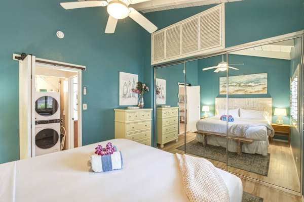 Your bright primary king bedroom includes mirrored closet doors, a ceiling fan, and convenient access to an in-unit washer and dryer.