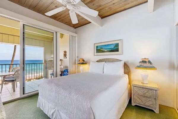 Bright Primary Bedroom with Vaulted Ceilings, Ocean Views, and Direct Balcony Access