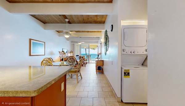In-Unit Stacked Washer and Dryer Setup with Open View to Dining Area