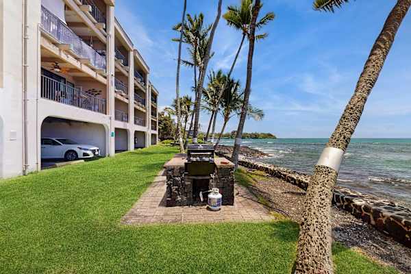Oceanfront Lawn and Seawall Adjacent to Resort Complex with Palm Trees