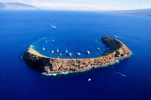 Take a boat excursion to Molokini Crater for world-class snorkeling and scuba diving in crystal-clear Hawaiian waters.