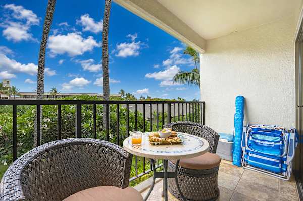 Soak in tropical breezes and lush green views from your private covered lanai, complete with patio seating and beach essentials ready for your beach day!
