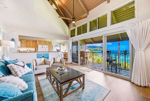 Open lounge presents stylish furnishings beside windows overlooking scenic island landscapes