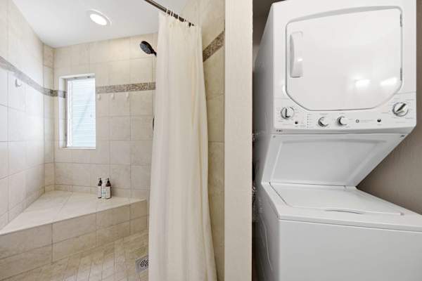 Updated bathroom offers a spacious vanity, refreshing shower, and washer & dryer.