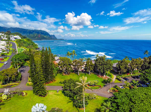 Surrounding landscape features tropical valleys, mountain ridges, and winding coastlines
