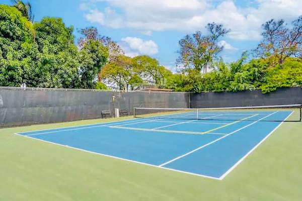 Stay active during your stay on the private tennis court, surrounded by lush palm trees and sunny skies.