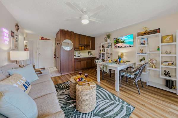 Open-Concept Living Area with Sofa, Dining Table & Kitchen